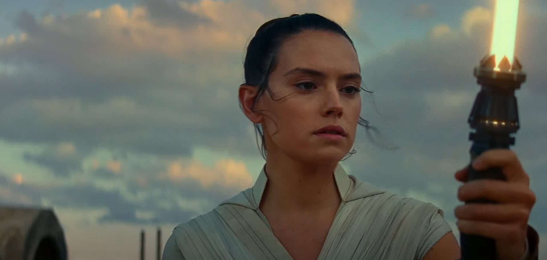 rey holding lightsaber